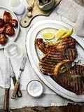 Barbecued T-bones with herb oil and Taleggio onions