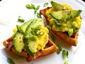 Chili waffle sandwiches with cheesy scrambled eggs, bacon, and avocado
