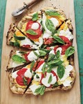 Grilled pizza with cheesy corn, fresh tomatoes, and basil
