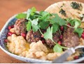Lamb and quinoa koftas on soft chickpeas with toasted pita bread