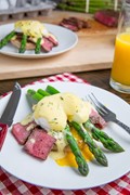 Steak and eggs Benedict with asparagus in Bearnaise sauce